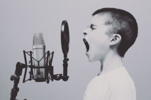 child screaming into recording microphone