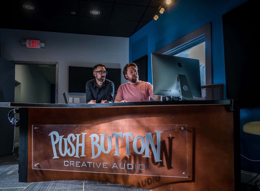 Photo of Yeosh and Jon of Push Button editing in the studio