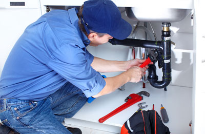 Photo of plumbing tech working on sink