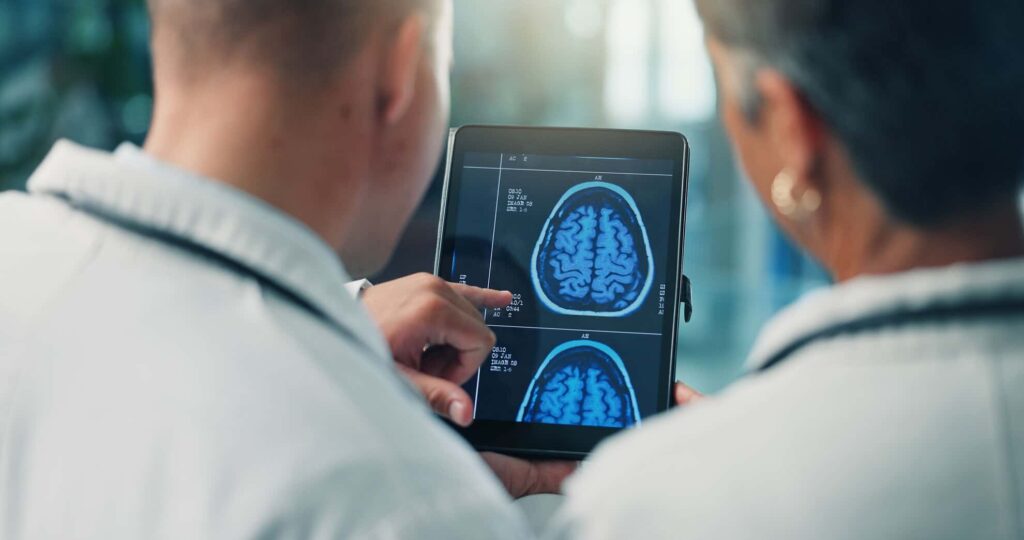 Hands, doctors and tablet for brain scan, neurology and MRI on screen for team collaboration at clinic. People, medical research and healthcare professional with app, xray or neuroscience at hospital